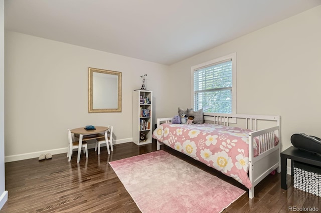 bedroom featuring wood finished floors and baseboards