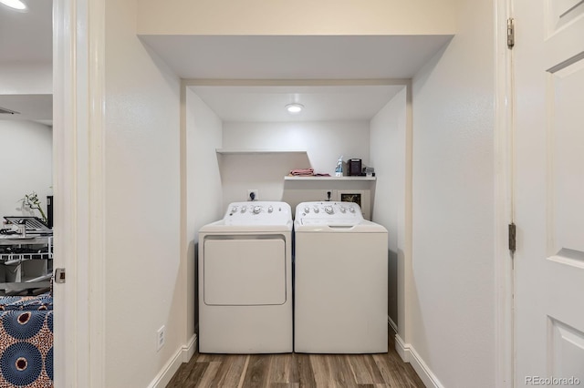 laundry room with separate washer and dryer, wood finished floors, and baseboards
