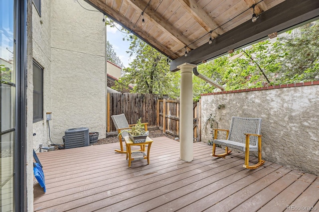 wooden terrace featuring a fenced backyard and cooling unit
