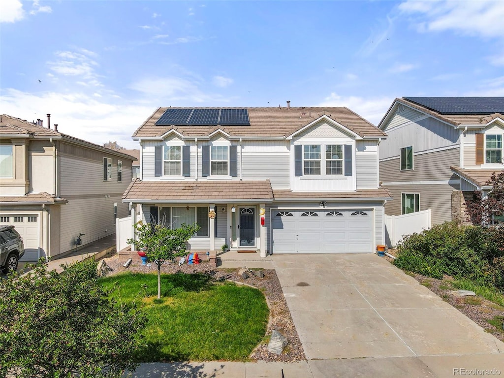 view of front of house featuring a garage, a porch, and solar panels