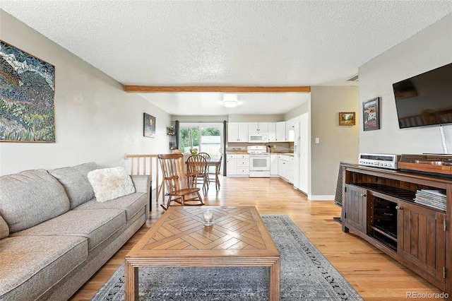 2011 S Vallejo St, Denver, CO 80223 - living area featuring light wood-type flooring and a textured ceiling