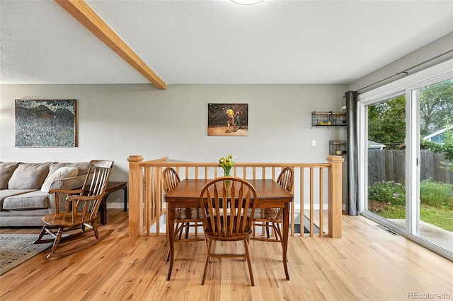 2011 S Vallejo St, Denver, CO 80223 - dining room featuring light wood-style floors and beam ceiling