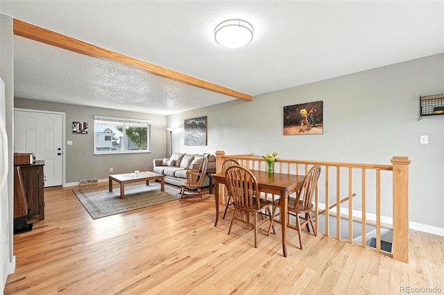 2011 S Vallejo St, Denver, CO 80223 - dining area featuring wood finished floors and beamed ceiling