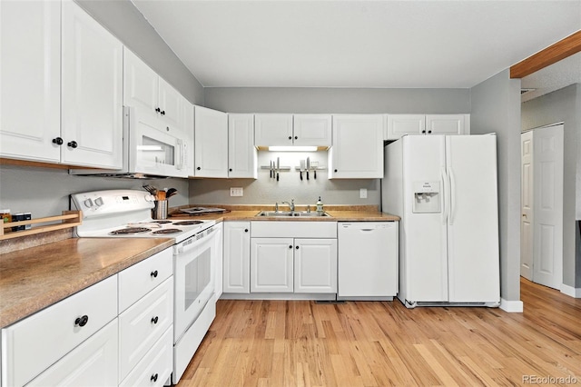 2011 S Vallejo St, Denver, CO 80223 - kitchen with white appliances, white cabinetry, light wood-style floors, and light countertops