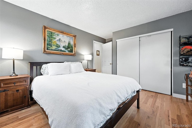 2011 S Vallejo St, Denver, CO 80223 - bedroom featuring light wood finished floors, a closet, and a textured ceiling