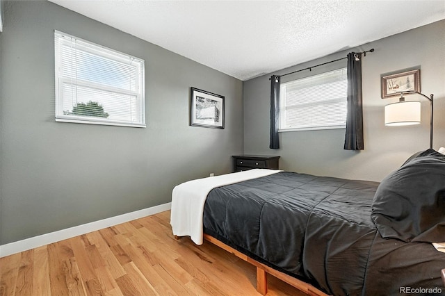 2011 S Vallejo St, Denver, CO 80223 - bedroom with wood finished floors and a textured ceiling