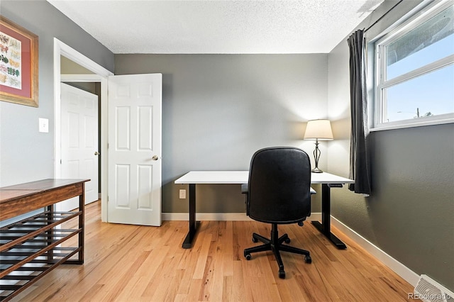 2011 S Vallejo St, Denver, CO 80223 - office featuring light wood-style flooring and a textured ceiling