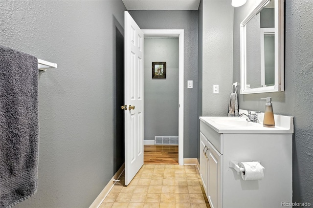 2011 S Vallejo St, Denver, CO 80223 - bathroom with vanity and a textured wall