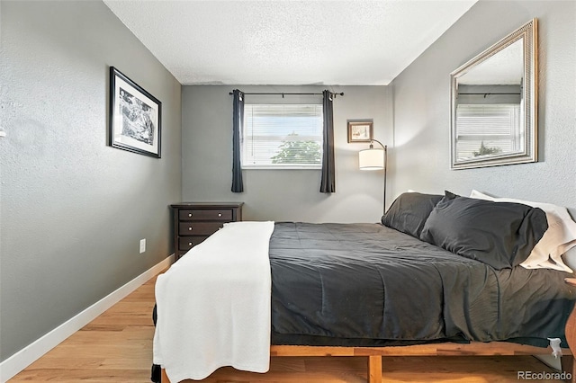2011 S Vallejo St, Denver, CO 80223 - bedroom with light wood-style floors and a textured ceiling