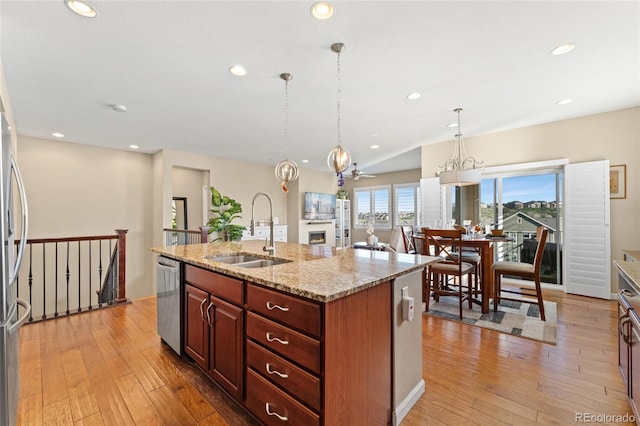 3278 Ghost Dance Dr, Castle Rock, CO 80108 - kitchen with a chandelier, light wood-style floors, stainless steel dishwasher, recessed lighting, and light stone countertops