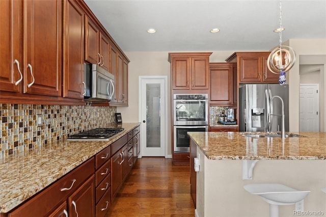 3278 Ghost Dance Dr, Castle Rock, CO 80108 - kitchen featuring appliances with stainless steel finishes, dark wood-type flooring, light stone counters, tasteful backsplash, and recessed lighting