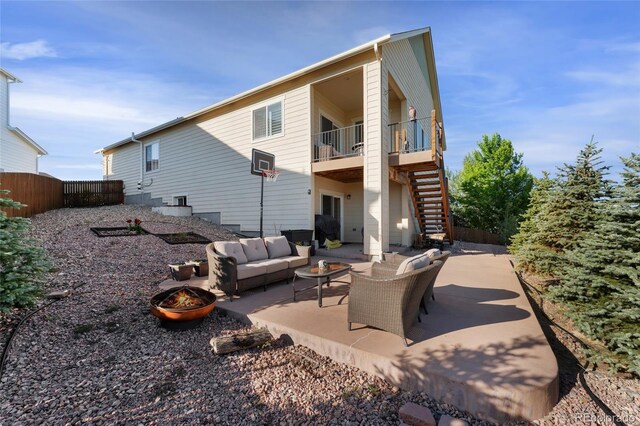 3278 Ghost Dance Dr, Castle Rock, CO 80108 - rear view of house featuring an outdoor living space with a fire pit, stairs, and a patio
