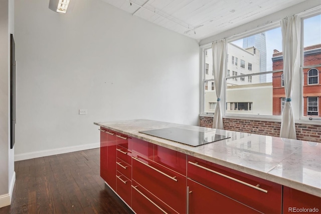 720 16th St Unit 306, Denver, CO 80202 - kitchen featuring red cabinets, dark wood finished floors, baseboards, and black electric cooktop