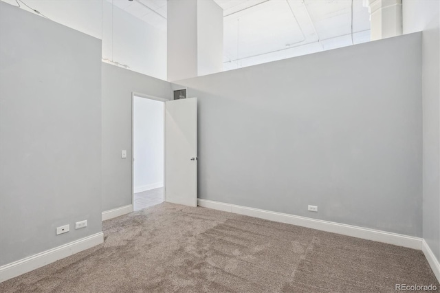 720 16th St Unit 306, Denver, CO 80202 - empty room featuring carpet floors, a towering ceiling, and baseboards