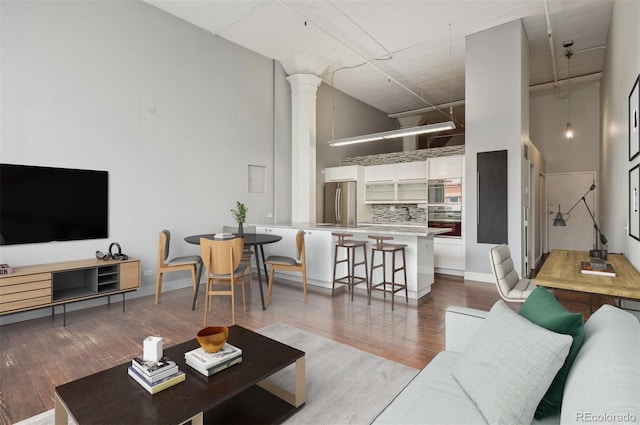 720 16th St Unit 306, Denver, CO 80202 - living room with a towering ceiling, ornate columns, and wood finished floors