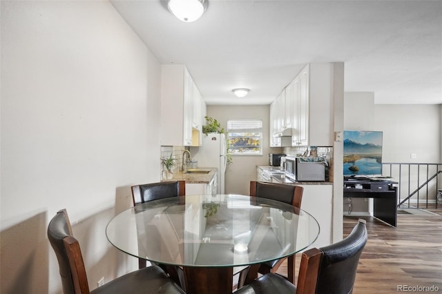 dining room featuring hardwood / wood-style floors and sink