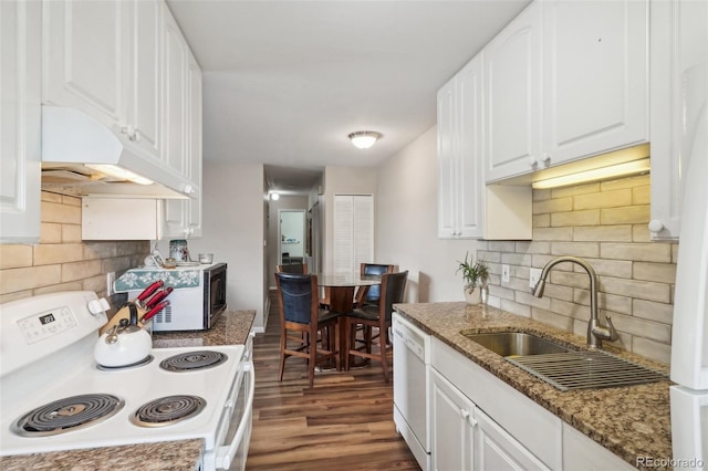 kitchen featuring white appliances, dark hardwood / wood-style floors, white cabinetry, and dark stone counters