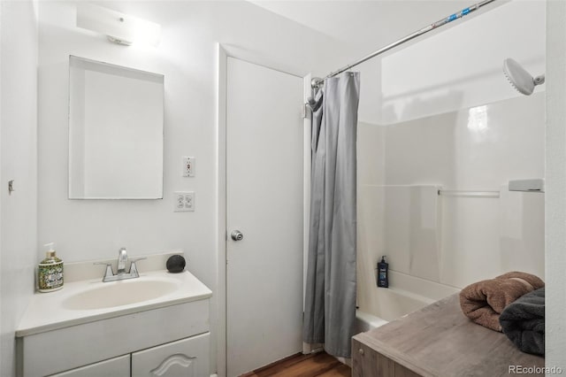 bathroom featuring hardwood / wood-style floors, vanity, and shower / tub combo with curtain