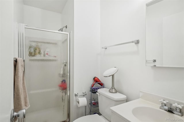 bathroom featuring vanity, toilet, and a shower with shower door