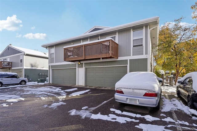 view of front of property featuring a balcony and a garage