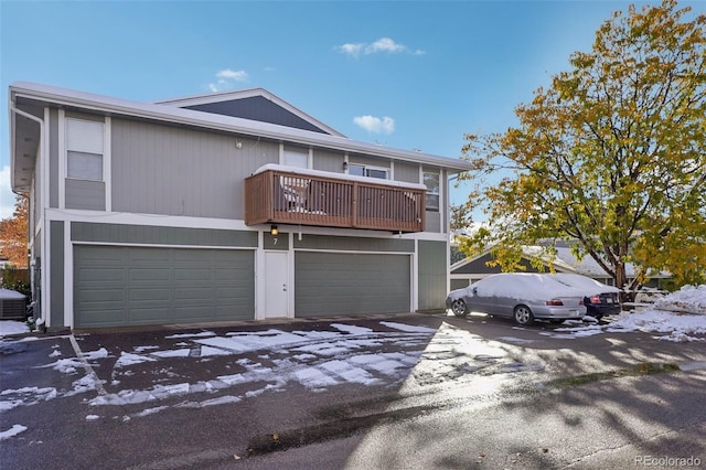 view of front facade featuring a balcony and a garage