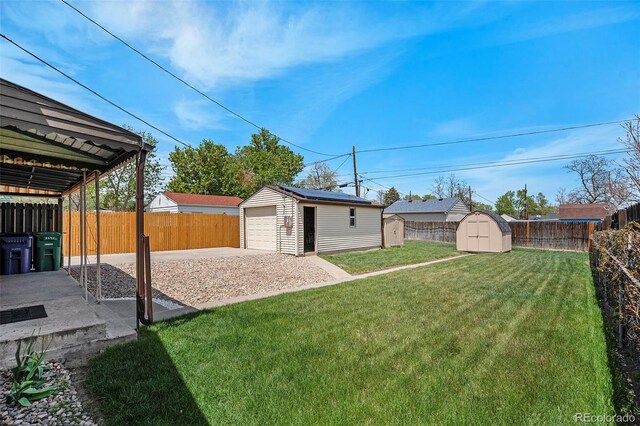view of yard featuring an outdoor structure, a garage, a shed, and concrete driveway