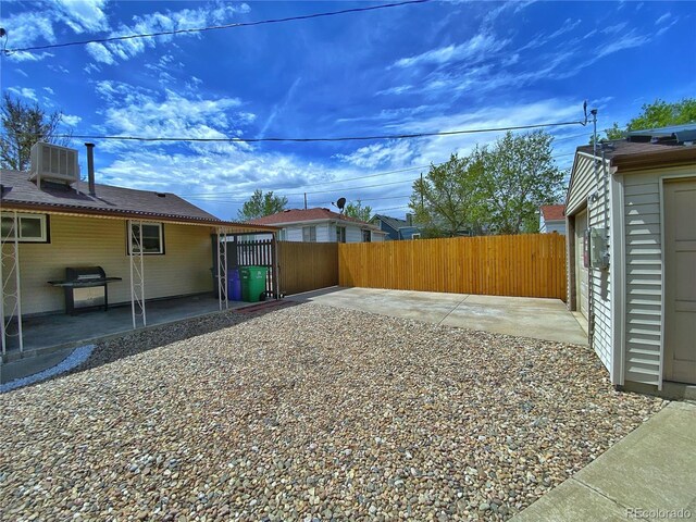 view of yard with a patio and fence
