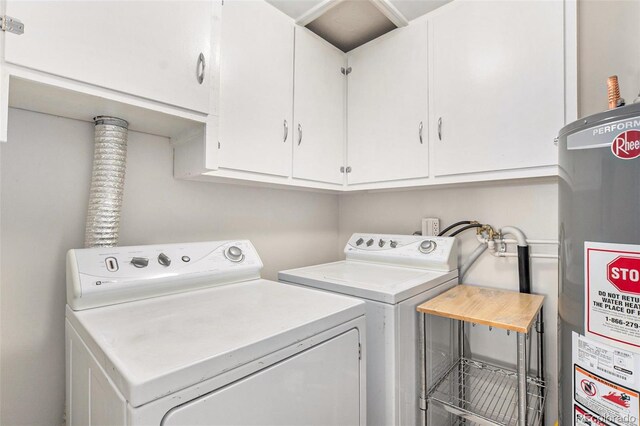 clothes washing area with water heater, cabinet space, and washer and clothes dryer