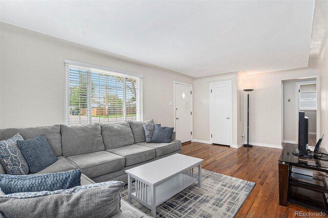 living area featuring wood finished floors and baseboards
