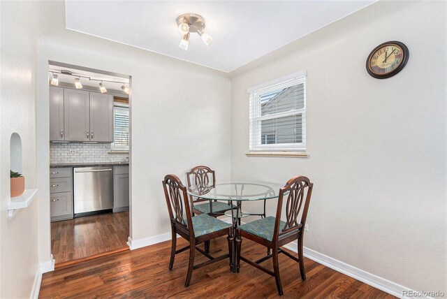 dining area with dark wood finished floors and baseboards