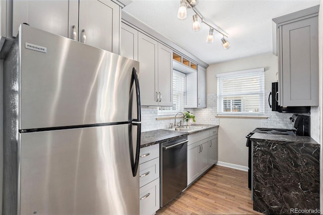 2235 W 46th Ave, Denver, CO 80211 - kitchen with appliances with stainless steel finishes, decorative backsplash, light wood-style floors, and gray cabinets