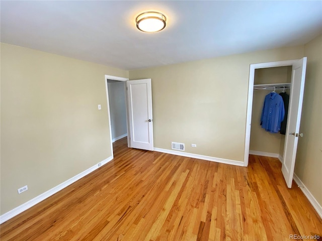 2235 W 46th Ave, Denver, CO 80211 - unfurnished bedroom featuring light wood-type flooring, a closet, and a spacious closet