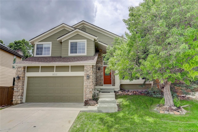 8652 Aberdeen Cir, Highlands Ranch, CO 80130 - view of front facade featuring stone siding, concrete driveway, an attached garage, and a front lawn
