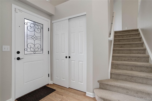 8652 Aberdeen Cir, Highlands Ranch, CO 80130 - foyer with light wood finished floors, stairway, and baseboards