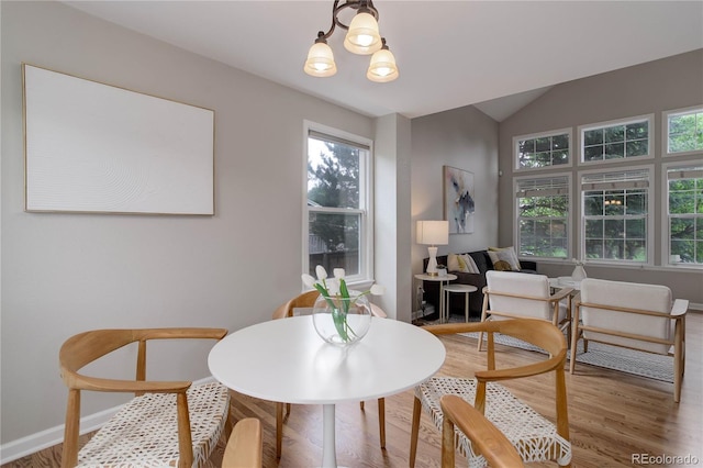 8652 Aberdeen Cir, Highlands Ranch, CO 80130 - dining space featuring light wood-style floors, healthy amount of natural light, baseboards, and vaulted ceiling