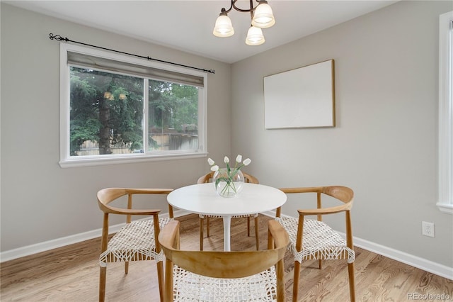 8652 Aberdeen Cir, Highlands Ranch, CO 80130 - dining space featuring light wood-style floors, baseboards, and a chandelier