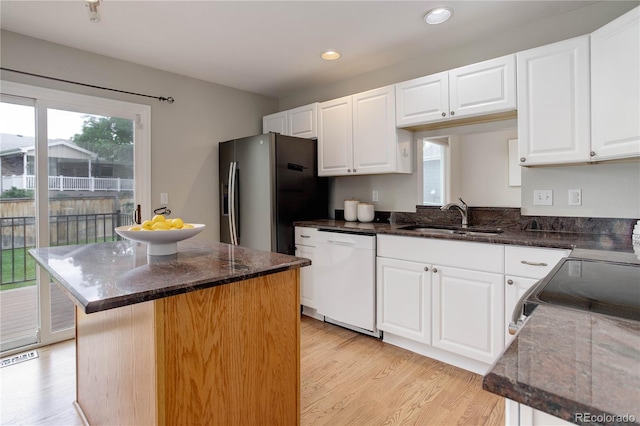 8652 Aberdeen Cir, Highlands Ranch, CO 80130 - kitchen with dishwasher, a sink, stainless steel fridge, light wood-style floors, and recessed lighting