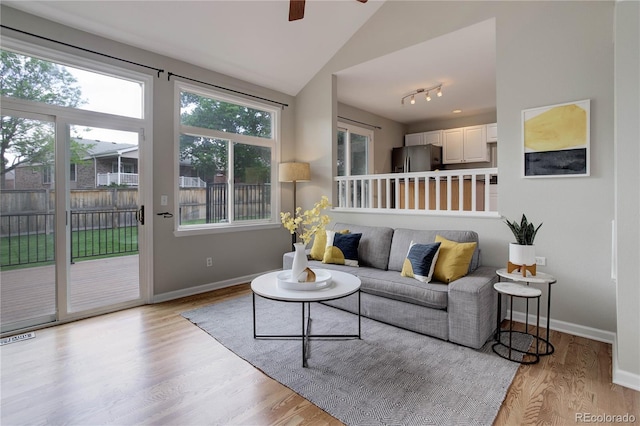 8652 Aberdeen Cir, Highlands Ranch, CO 80130 - living area with wood finished floors, ceiling fan, baseboards, and lofted ceiling