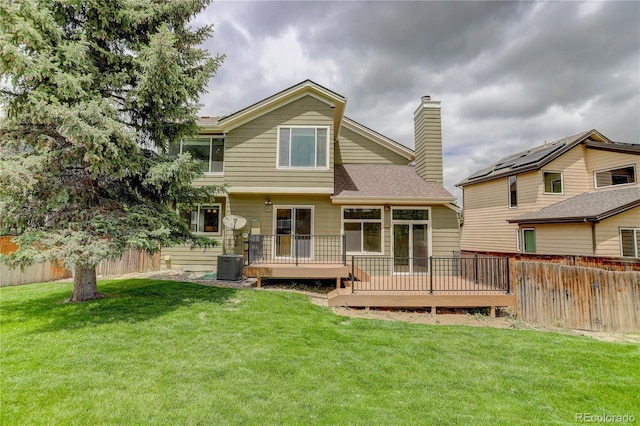 8652 Aberdeen Cir, Highlands Ranch, CO 80130 - back of property featuring a wooden deck, a chimney, cooling unit, and roof with shingles