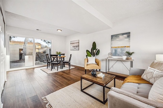 living room featuring baseboards and wood finished floors