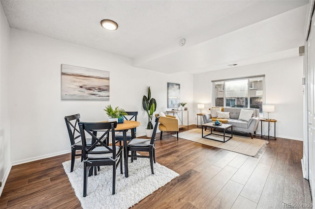 dining room featuring baseboards and wood finished floors