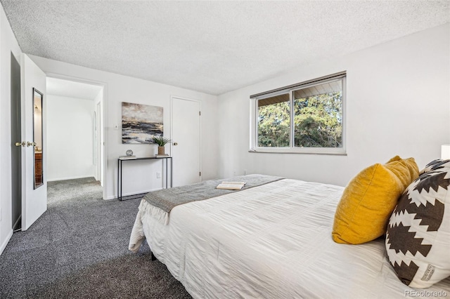 bedroom featuring a textured ceiling, carpet, and baseboards