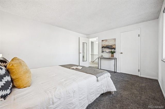 bedroom featuring carpet floors and a textured ceiling