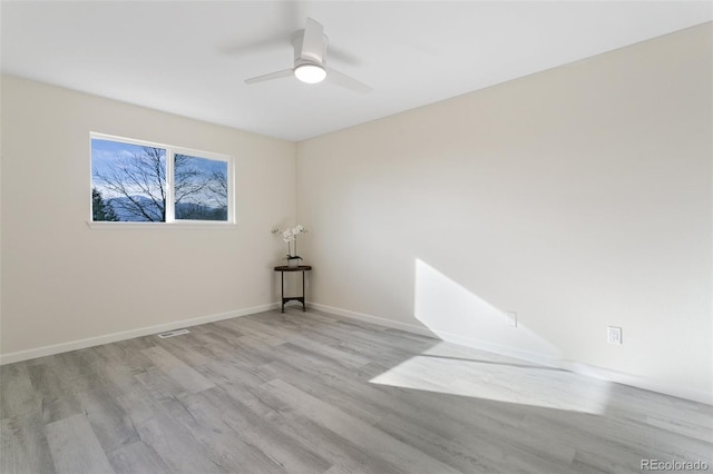 spare room featuring ceiling fan and light hardwood / wood-style flooring