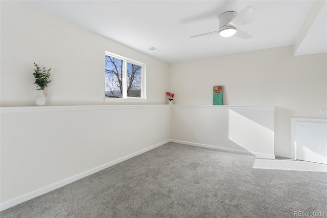 carpeted empty room featuring ceiling fan