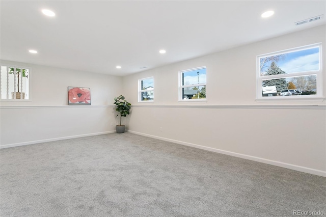 carpeted spare room with a healthy amount of sunlight