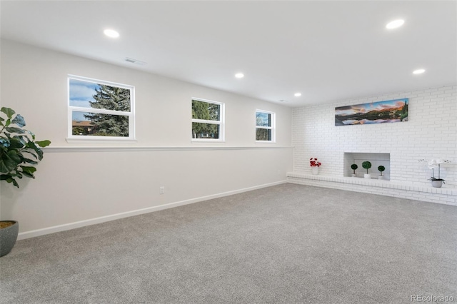 basement with a fireplace and carpet floors