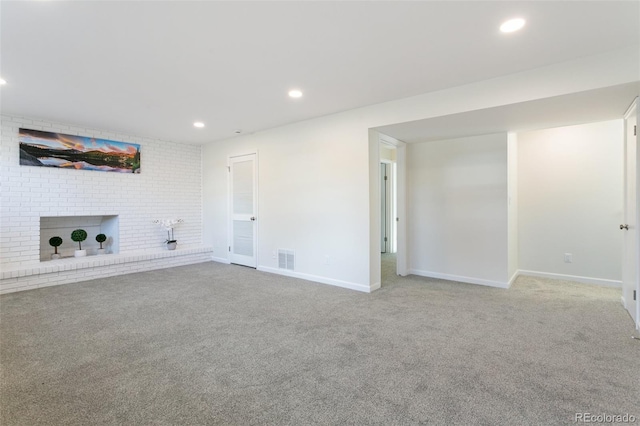 unfurnished living room with carpet and a fireplace