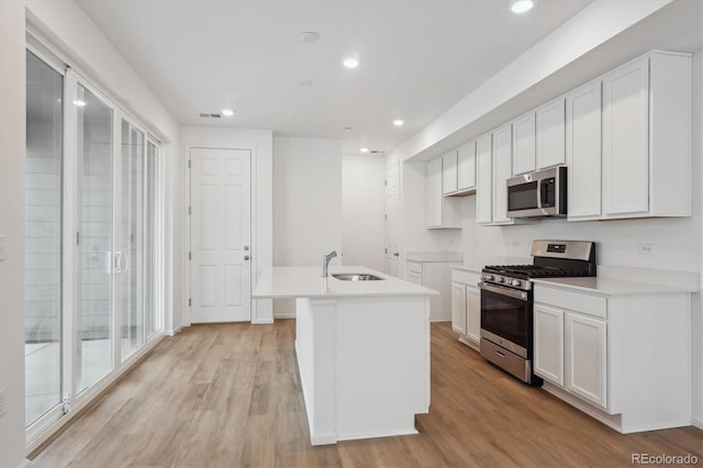 1242 Penner Dr, Erie, CO 80026 - kitchen featuring a sink, visible vents, light wood-style floors, and appliances with stainless steel finishes