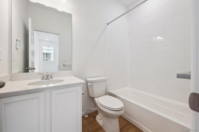 1242 Penner Dr, Erie, CO 80026 - full bathroom featuring shower / washtub combination, wood finished floors, toilet, and vanity